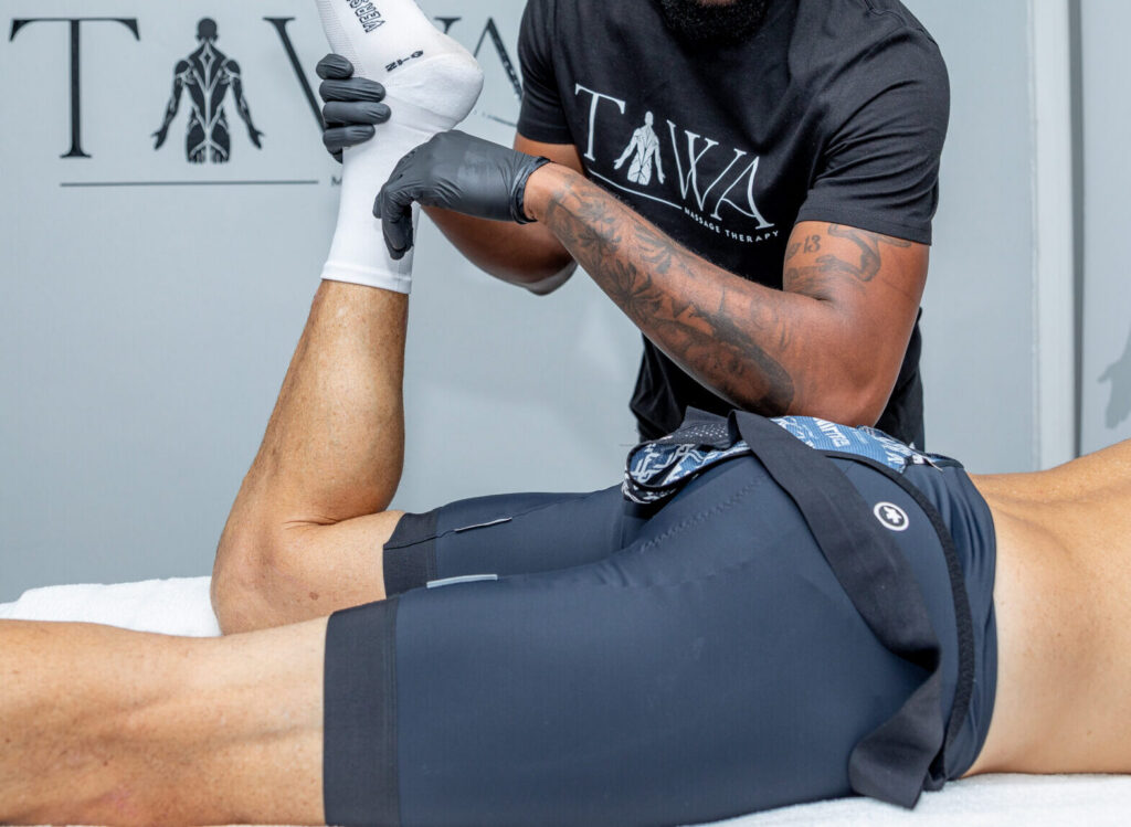 Athlete receiving sports massage and sports stretching in Cape Town.
